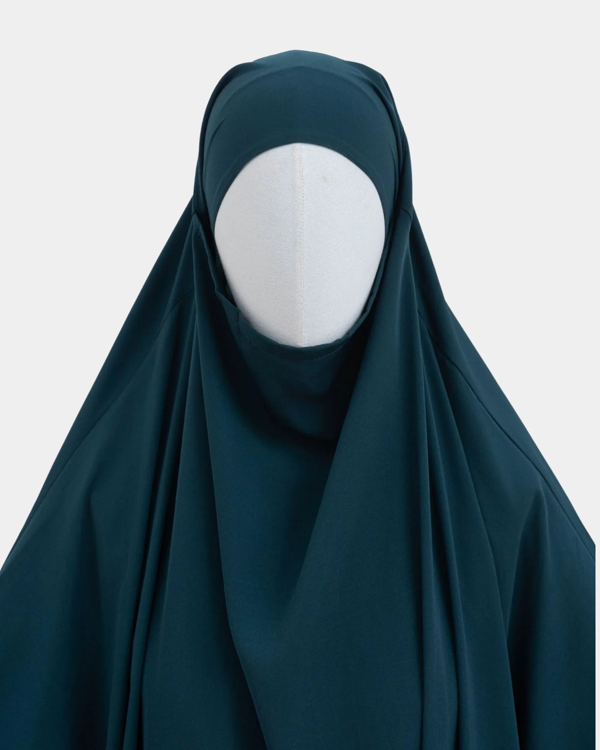 Capuche du jilbab bleu pétrole et drapé du tissu sur le buste