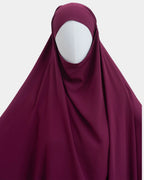Capuche du jilbab fuchsia et drapé du tissu sur le buste