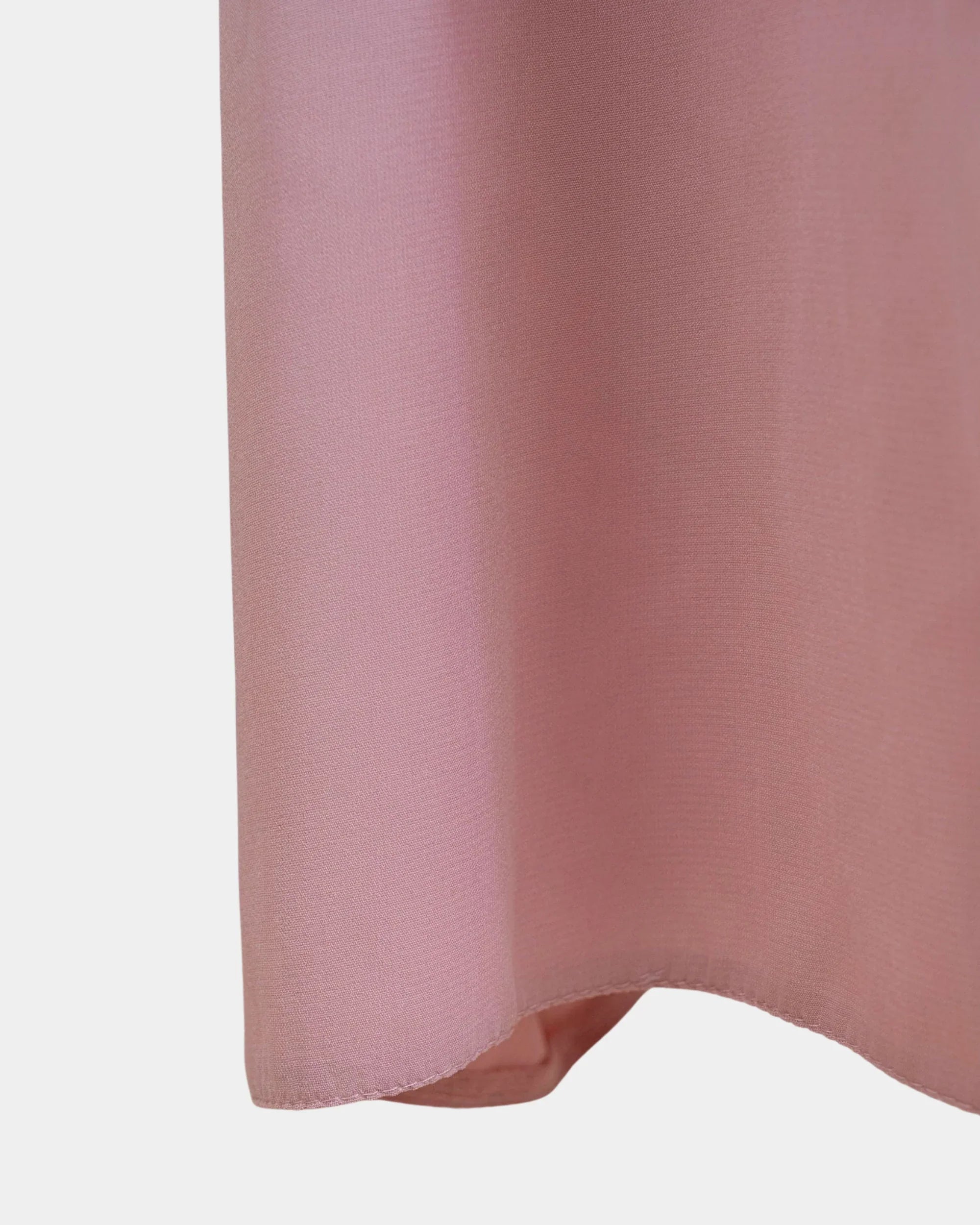 Bas du jilbab rose, ourlet surpiqué et finition arrondie du tissu